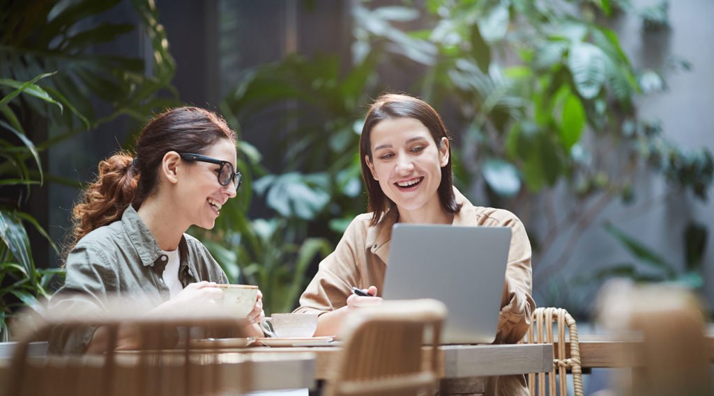 two women chatting with laptop